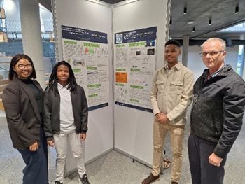 A group of people standing in a roomDescription automatically generated